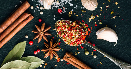 Mix of spices on a dark background, seasoning for cooking