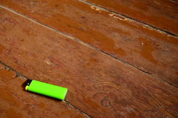 green lighter on wooden background