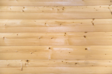 Background of a block house of coniferous trees with a beautiful pattern of the structure of trees knots. Design backgrounds texture construction. © Victor1153