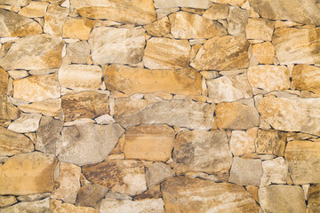 Background of irregular cobblestones light beige color. Design backgrounds texture construction.