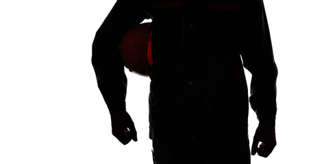 silhouette of a man in overalls with a protective helmet under his arm on a white isolated...