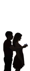 silhouette of a young couple in love on white isolated background, man came up behind to woman to make a surprise with box present, concept romantic holidays