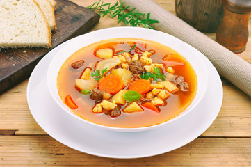 Goulash soup on wooden table.