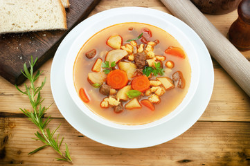 Goulash soup on wooden table.