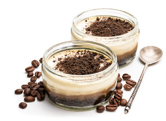 Obraz na płótnie Canvas Layered creamy cappuccino cheesecakes in glass jar isolated on white