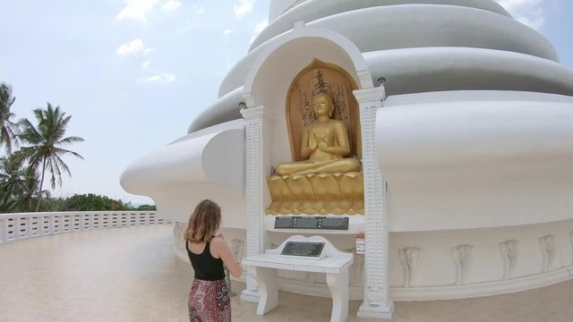 young woman is praying in japanese peace pagoda