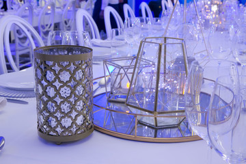 table setting in a blue light with white and gold