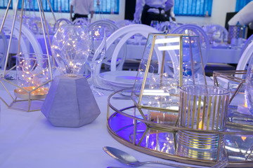 table setting in a blue light with white and gold