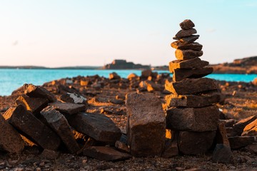 A pile of rocks in the sunset