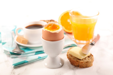 boiled egg, orange juice and coffee cup