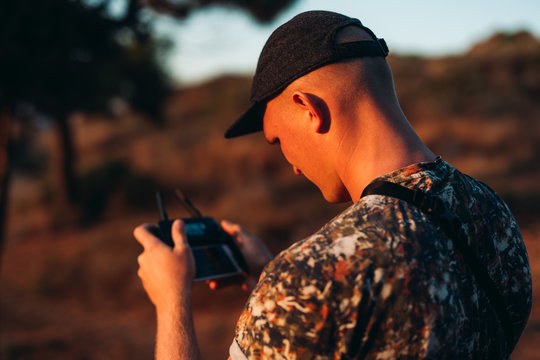 Young Man In Hat Flying Drone