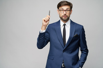 Studuo shot of thinking solving problem businessman wearing suit holding pen