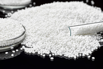 Closeup of a large slide of white plastic polymer granules