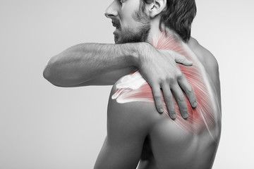Shoulder pain. Man holding a hand on shoulder