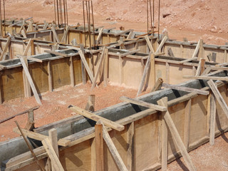 Building ground beam under construction using temporary timber plywood at the site. Reinforced by the reinforcement steel to strengthen the structure.   