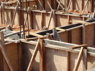 Building ground beam under construction using temporary timber plywood at the site. Reinforced by the reinforcement steel to strengthen the structure.   