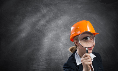 Building inspector looking through magnifier