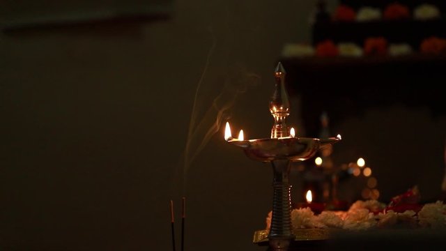 Indian wedding ceremony : Lord sculpture and  decorative coper kalash with green leaf and coconut 