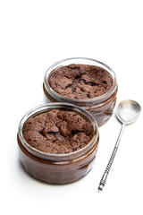 Obraz na płótnie Canvas Homemade delicious chocolate souffle in glass jars isolated on white