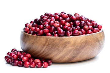 Fresh cranberries in wooden bowl isolated on white