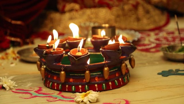 Indian wedding ceremony : Lord sculpture and  decorative coper kalash with green leaf and coconut 