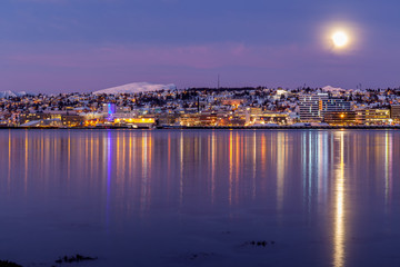 Obraz premium Amazing sunrise with amazing magenta color and moon over Tromso, Norway. Polar night. long shutter speed