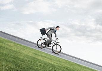 Young man riding bicycle on highway