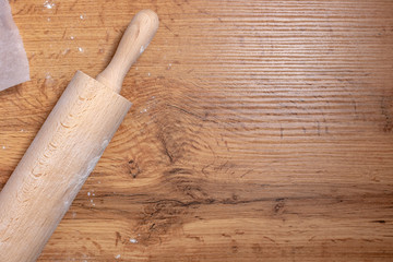 Close up wooden rolling pin on wooden table top view
