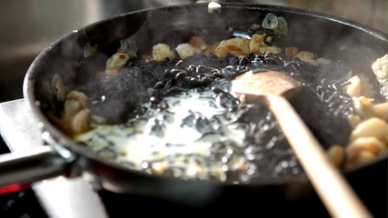 Squid Ink black Pasta With Shrimps on frying pan