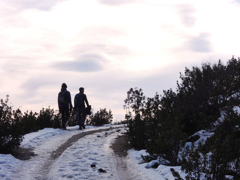 Two mountaineers walk through the Port of Canencia. National Park of the Sierra de Guadarrama. Madrid's community. Spain