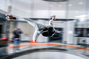 Adrenaline. Extreme sky for free people. No rules in open air. Parachutist in white suit is in free fall. Skydiving is a sport of the future. 