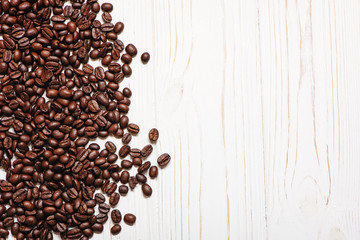 Roasted coffee beans on wooden background.