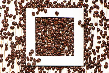 Creative layout with white frame and roasted coffee beans.