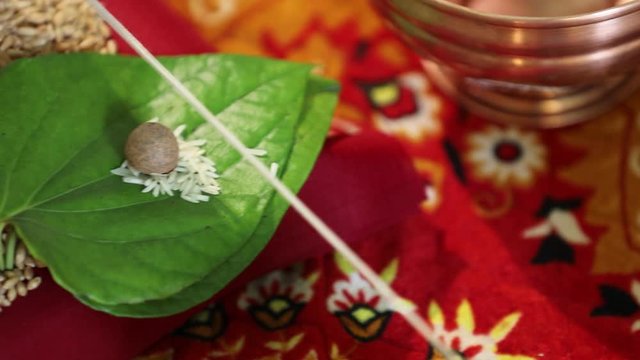 Indian wedding ceremony : Lord sculpture and  decorative coper kalash with green leaf and coconut 