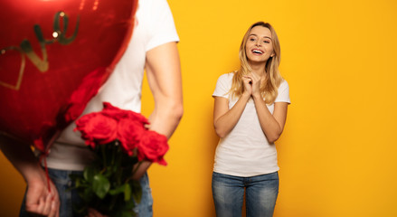 A present for you. Close-up photo of a man, who is holding a present for his girlfriend behind his...