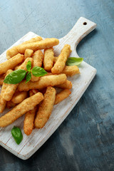 Crispy Halloumi cheese sticks Fries with sweet hot sauce on white wooden board