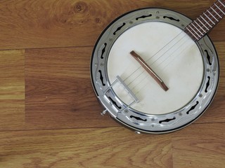 Close-up of a samba banjo, a Brazilian string musical instrument, on a wooden surface. It is widely used in samba and pagode ensembles, popular Brazilian rhythms.