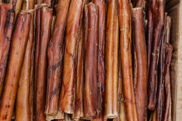 Dried beef pizzle in a cardboard box. Bully sticks for dogs. Chewing dental treats. Pet supplies....