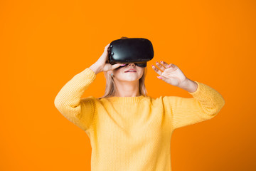 Computer game player uses virtual reality. A young woman in a virtual reality helmet