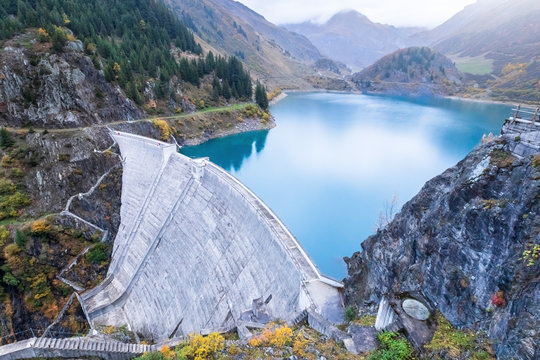 Reservoir lake and water dam in French Alps to produce hydroelectricity, sustainable development using renewable energy and hydropower