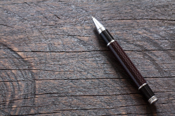 Vintage pen on wooden background