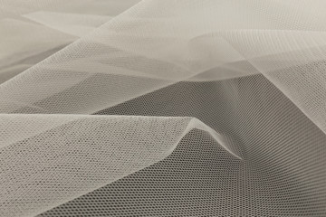 Beautiful close up of white tulle fabric with textile texture background