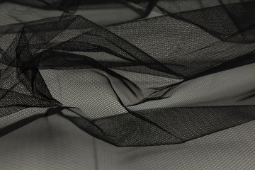 Beautiful close up of black tulle fabric with textile texture background