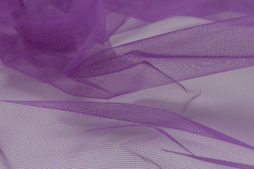 Beautiful close up of lila tulle fabric with textile texture background