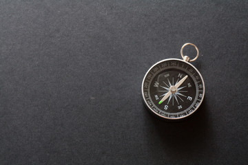 Compass on black paper background