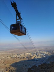 Masada, Israel December 23th 2019. Funicular to Masada mountain. elevator up the mountain in the desert against the blue sky