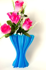 blue cup full of small pink roses