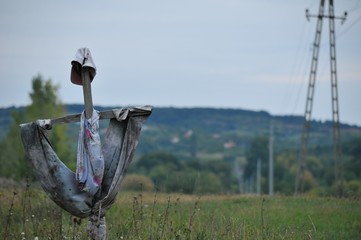 A cross with rags swaying in the wind
