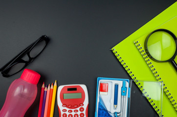 Various school supplies. Studying, education and back to school concept. Black background and selective focus.