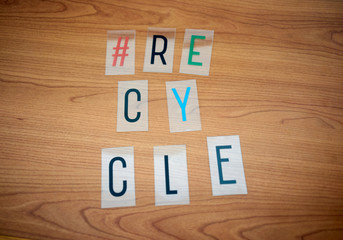 the word "recycle" made by plastic letter pieces